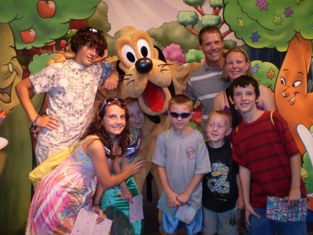 Family of eight with Pluto in EPCOT