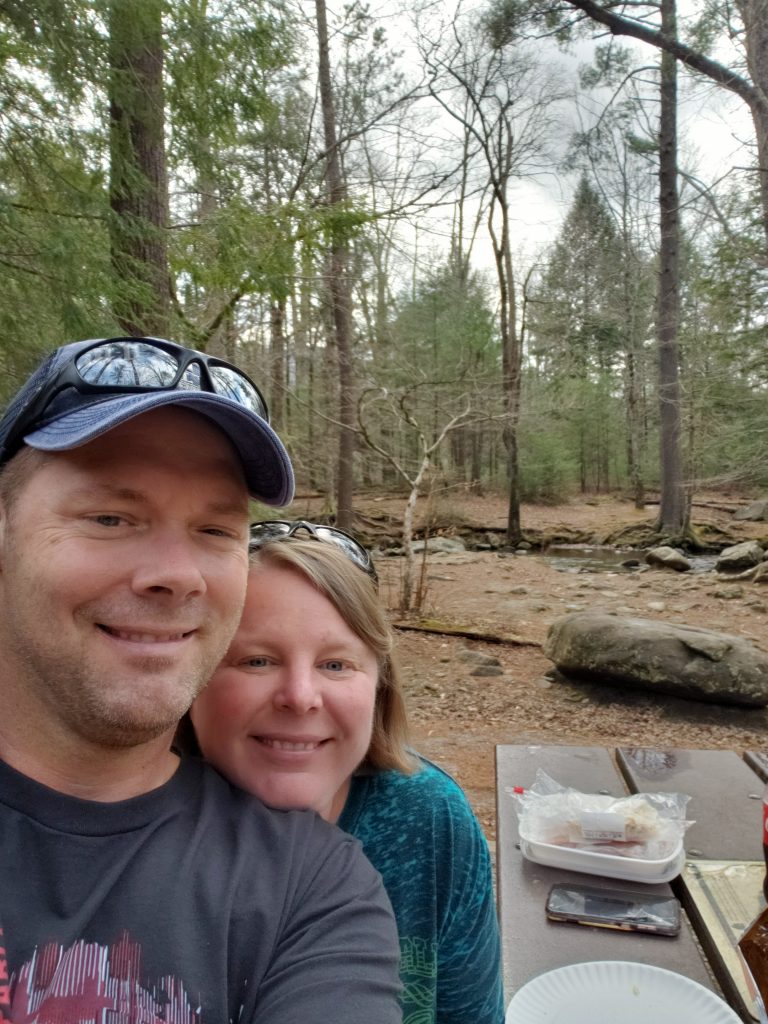 Husband and wife taking picture together while having a picnic in a State Park