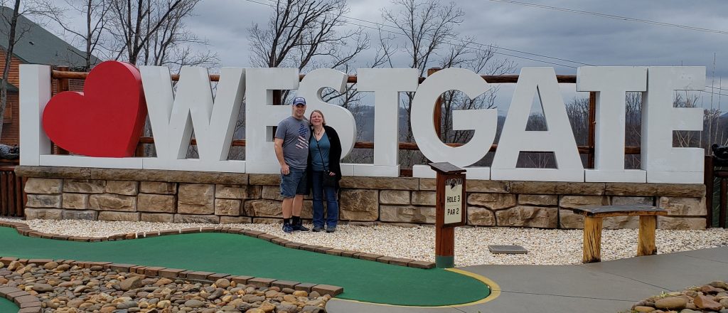 Husband and wife with Westgate sign in Gatlinburgh, TN
