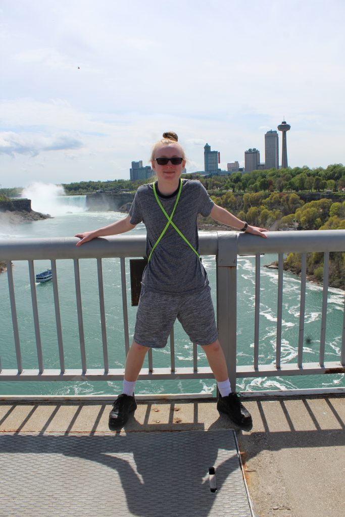 Teen boy standing at the border between the USA and Canada