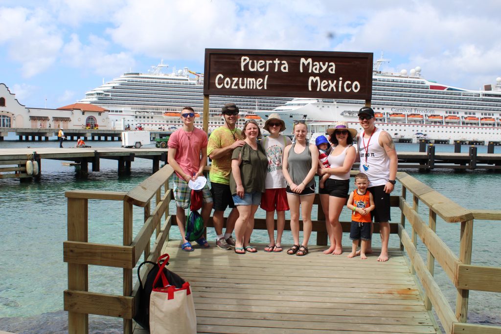 Three generations of family in front of cruise ships in Cozumel Mexico