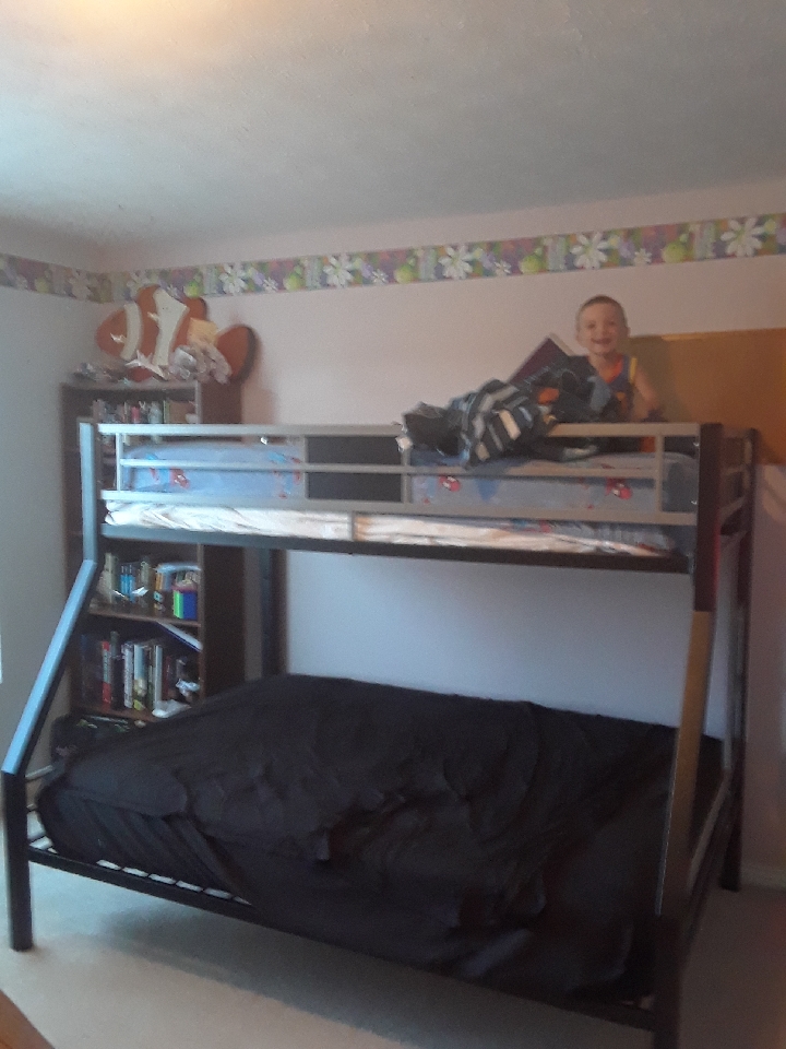 preschool child on top of bunk bed