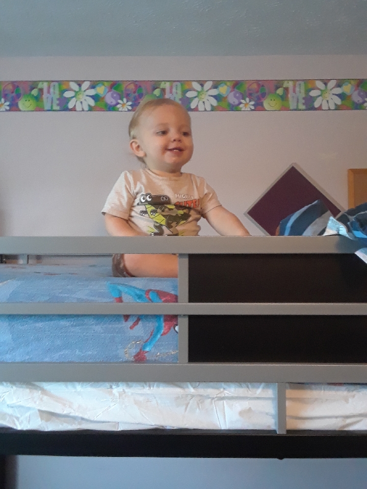 baby on top of bunk bed