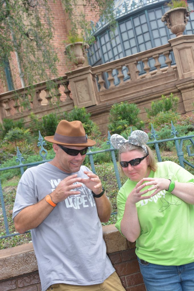 Husband and wife outside of the Haunted Mansion in Magic Kingdom at Walt Disney World