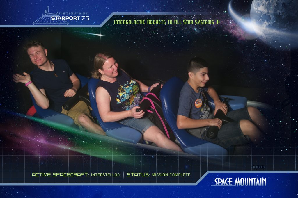 Three people on Space Mountain in Disney's Magic Kingdom