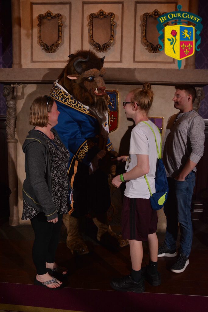 Two teen boys with the Beast in Disney's Magic Kingdom