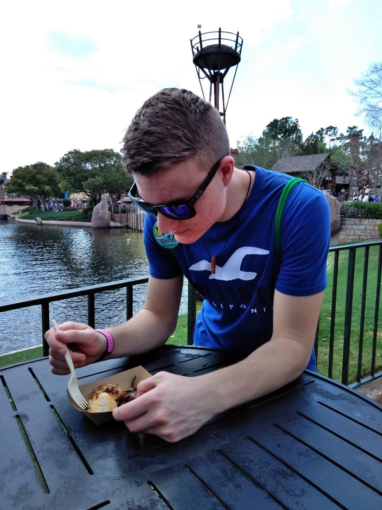 Teen boy eating in EPCOT