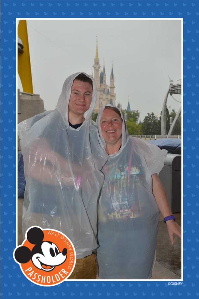 Mom and son in rain ponchos at Magic Kingdom