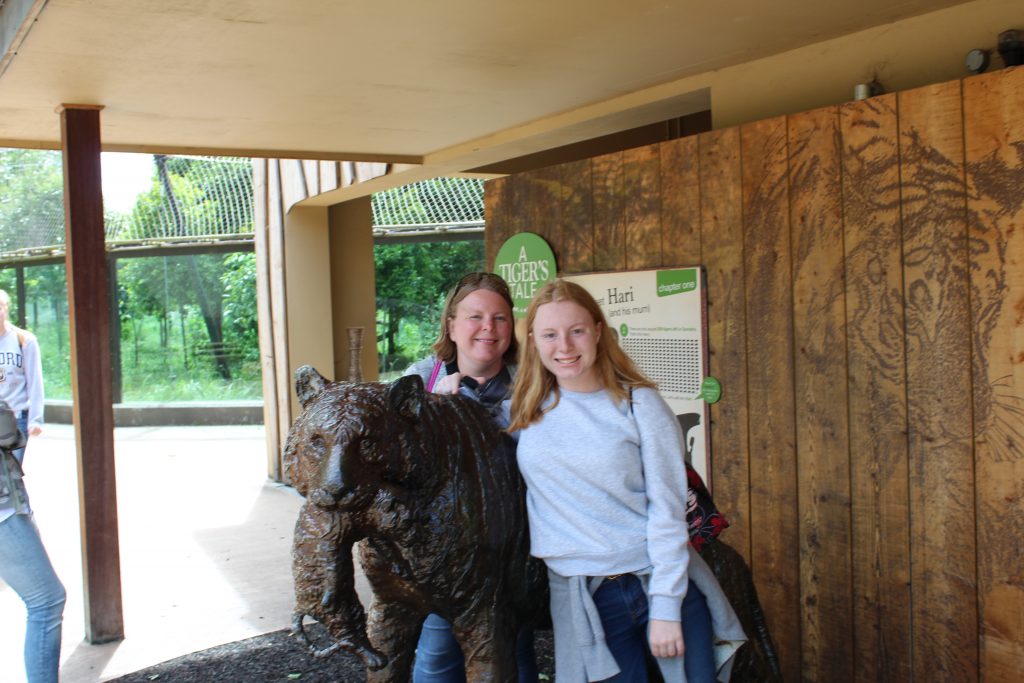 Mom and daughter with statue at London Zoo