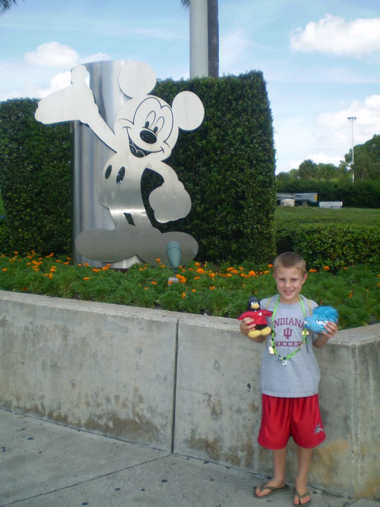 Child with Mickey Mouse statue